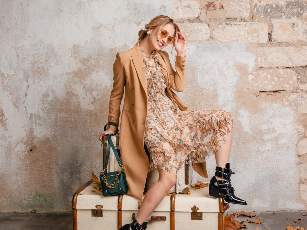 Attractive Stylish Blonde Woman Beige Coat Sitting Suitcases Against Wall Street
